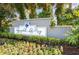 Elegant community entrance sign, 'Regency Park at Lake Mary Luxury Condominiums' surrounded by lush greenery and colorful flowers at 2501 Grassy Point Dr # 103, Lake Mary, FL 32746
