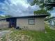 View of the backyard of the house, with exterior wall and air conditioning system at 2506 Perrine Pl, Orlando, FL 32808