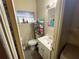 Modest bathroom featuring a white vanity, toilet, and natural light from a window at 2506 Perrine Pl, Orlando, FL 32808
