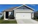 Charming home exterior with a two-car garage and well-maintained landscaping at 2963 Waterlily Way, Poinciana, FL 34759