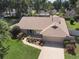 Aerial view of a well-kept home with a landscaped front yard and a two-car garage at 3300 Se 22Nd Ave, Ocala, FL 34471