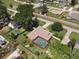 Backyard aerial view showing a beautiful home with a screened-in pool and lush greenery at 3300 Se 22Nd Ave, Ocala, FL 34471