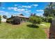 Lush backyard featuring a well-maintained lawn and mature trees at 3300 Se 22Nd Ave, Ocala, FL 34471
