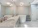 This modern bathroom is well-lit with a soaking tub and double sinks with vanity at 3300 Se 22Nd Ave, Ocala, FL 34471