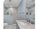 This modern bathroom is well-lit with a walk-in shower and single sink with vanity at 3300 Se 22Nd Ave, Ocala, FL 34471