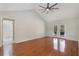 Bright primary bedroom with hardwood floors and french doors leading to the backyard pool and patio area at 3300 Se 22Nd Ave, Ocala, FL 34471