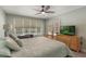 Inviting bedroom with a ceiling fan and view of the backyard pool at 3300 Se 22Nd Ave, Ocala, FL 34471