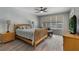 Comfortable bedroom with ample natural light, ceiling fan, and wood-look tile floors at 3300 Se 22Nd Ave, Ocala, FL 34471