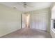 This carpeted bedroom has neutral paint, a ceiling fan, and a closet at 3300 Se 22Nd Ave, Ocala, FL 34471