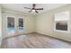 Bedroom showcasing wood-look flooring and a glass door leading to the pool at 3300 Se 22Nd Ave, Ocala, FL 34471