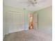 This carpeted bedroom has neutral paint, a ceiling fan, and a closet at 3300 Se 22Nd Ave, Ocala, FL 34471