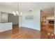 Inviting dining area with hardwood floors and elegant lighting showcases a view into the cozy living room at 3300 Se 22Nd Ave, Ocala, FL 34471