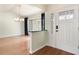 Bright foyer with hardwood floors and white trim showcases a modern entry door and elegant chandelier at 3300 Se 22Nd Ave, Ocala, FL 34471
