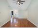 Spacious living room with hardwood flooring, vaulted ceiling, and modern ceiling fan offers a bright open layout at 3300 Se 22Nd Ave, Ocala, FL 34471
