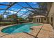 Inviting screened-in pool with brick paved deck and sunroom entrance at 3300 Se 22Nd Ave, Ocala, FL 34471