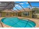 This home features a large screened-in pool with an attached patio at 3300 Se 22Nd Ave, Ocala, FL 34471