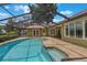 This home features a large screened-in pool with an attached patio and hot tub at 3300 Se 22Nd Ave, Ocala, FL 34471