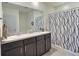 Bathroom featuring a double sink vanity with modern fixtures and a decorative shower curtain at 3329 Royal Tern Dr, Winter Haven, FL 33881