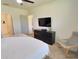 Bedroom featuring a comfortable bed, television, and a comfortable chair at 3329 Royal Tern Dr, Winter Haven, FL 33881