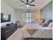Bright bedroom featuring a comfortable bed, accent wall, and a large television at 3329 Royal Tern Dr, Winter Haven, FL 33881