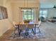 Bright dining room with modern table, stylish chairs, pendant lighting, and scenic backyard view at 3329 Royal Tern Dr, Winter Haven, FL 33881