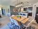 Open dining area featuring modern table, stylish chairs, and pendant lighting adjacent to the kitchen at 3329 Royal Tern Dr, Winter Haven, FL 33881