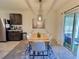 Dining area with modern table, stylish chairs, and sliding glass doors to a patio at 3329 Royal Tern Dr, Winter Haven, FL 33881