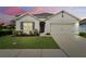 Charming single-story home showcasing a manicured lawn, neutral tones, and an attached two-car garage at 3329 Royal Tern Dr, Winter Haven, FL 33881