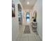 Inviting hallway featuring tiled flooring, arched doorways, neutral walls, and decorative accents at 3329 Royal Tern Dr, Winter Haven, FL 33881