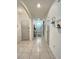 Spacious hallway with tile floors, arched doorways, neutral walls, and a view of the front door at 3329 Royal Tern Dr, Winter Haven, FL 33881
