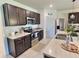 Modern kitchen boasts stainless steel appliances, ample counter space, and sleek dark cabinetry at 3329 Royal Tern Dr, Winter Haven, FL 33881