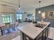 Open-concept kitchen flows into the dining and living areas, featuring a large island and modern lighting at 3329 Royal Tern Dr, Winter Haven, FL 33881