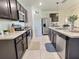 Modern kitchen boasts stainless steel appliances, ample counter space, and sleek dark cabinetry at 3329 Royal Tern Dr, Winter Haven, FL 33881