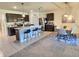 Open-concept kitchen features a spacious island with seating, stainless steel appliances, and a dining area at 3329 Royal Tern Dr, Winter Haven, FL 33881