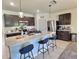 Stylish kitchen with a large island, pendant lighting, stainless steel appliances, and dark wood cabinets at 3329 Royal Tern Dr, Winter Haven, FL 33881