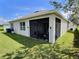 View of a screened patio on back of house including backyard and some yard equipment at 3329 Royal Tern Dr, Winter Haven, FL 33881