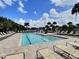 Community pool with lounge chairs under a partly cloudy sky, great for relaxation and recreation at 3329 Royal Tern Dr, Winter Haven, FL 33881