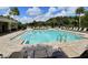 Community pool with lounge chairs under a partly cloudy sky, great for relaxation and recreation at 3329 Royal Tern Dr, Winter Haven, FL 33881