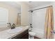 Bathroom features a granite countertop, dark cabinets, and a tub with a shower at 337 Southern Winds Blvd, Deland, FL 32720