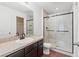Bathroom features granite countertops, a dark vanity, a walk-in tiled shower and wood-look floors at 337 Southern Winds Blvd, Deland, FL 32720