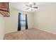 Bedroom features a window with blinds and blue curtains, neutral carpet and ceiling fan at 337 Southern Winds Blvd, Deland, FL 32720