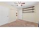 Bedroom features neutral carpet and storage shelving, perfect for organization and decor at 337 Southern Winds Blvd, Deland, FL 32720