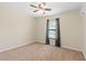 Bedroom with neutral carpet features a ceiling fan and a window with gray curtains at 337 Southern Winds Blvd, Deland, FL 32720