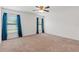 Spacious bedroom features neutral carpet, two windows with blue drapes and a ceiling fan at 337 Southern Winds Blvd, Deland, FL 32720