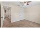 Bedroom features neutral carpet, a ceiling fan, and multiple doorways for easy access at 337 Southern Winds Blvd, Deland, FL 32720