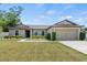 Lovely single-story home with a well-manicured lawn and an attached two-car garage at 337 Southern Winds Blvd, Deland, FL 32720