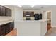 Open kitchen featuring dark cabinets, granite countertops, and modern appliances at 337 Southern Winds Blvd, Deland, FL 32720