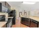 View of kitchen featuring stainless steel appliances and a breakfast bar that overlooks the living room at 337 Southern Winds Blvd, Deland, FL 32720