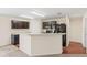 Eat-in kitchen with dark wood cabinets, breakfast bar and black appliances at 337 Southern Winds Blvd, Deland, FL 32720