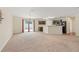 Open concept living area with a kitchen bar and sliding glass door to the back patio at 337 Southern Winds Blvd, Deland, FL 32720